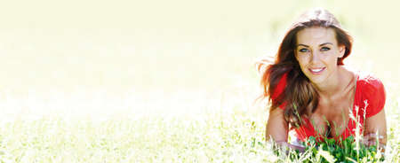Portrait of young woman in countryside at spring bokeh background with copy space for textの写真素材