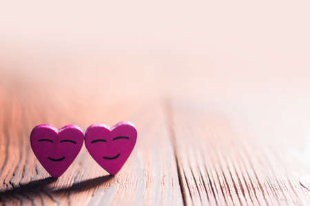 Two smiling pink hearts on wooden background, relationship valentines day conceptの写真素材