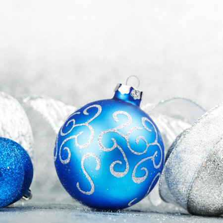 Christmas decorative balls on light silver bokeh backgroundの写真素材