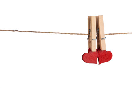 Clothes pegs and two red hearts on rope isolated on white background Valentines day conceptの写真素材