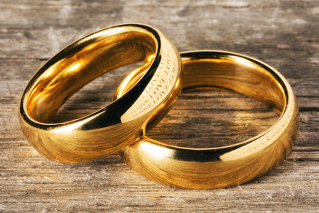 Two golden wedding rings on wooden backgroundの写真素材