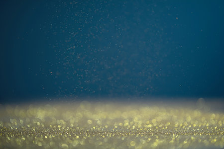 Golden and blue christmas background with bokeh lightsの写真素材