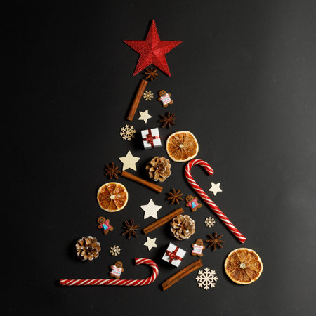 Christmas Tree made of decor on black paper background. Christmas Holiday Concept. Flat Layの写真素材