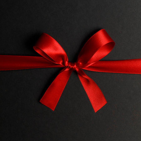 Red gift bow on black backgroundの写真素材