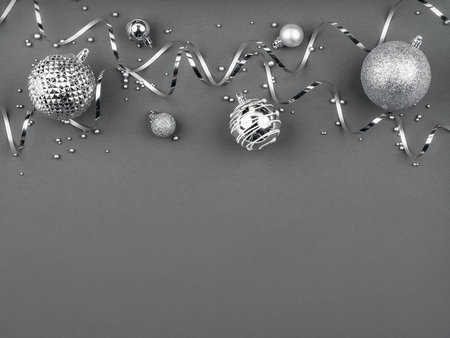 christmas frame with silver balls and fir branches on grayの写真素材