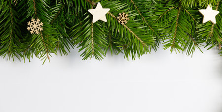 Natural fir Christmas tree border frame and wooden decor isolated on white , copy space for textの写真素材