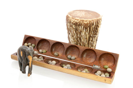 African drum carved from tree with elefant and awale gameの写真素材