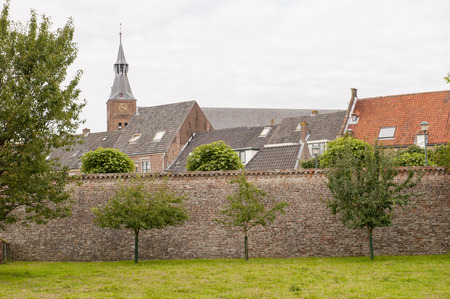 Historic city center behind ancient town wall at the city of Hattem, the Netherlands.の写真素材