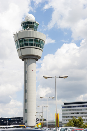 AMSTERDAM SCHIPHOL, THE NETHERLANDS - AUGUST 10, 2014  White Schiphol airport control tower against cloudy skyのeditorial素材