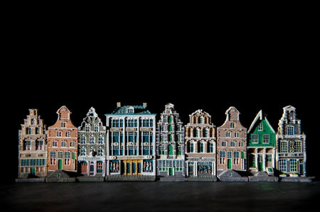 Row of traditional Dutch canal houses with eerie shadows against a black backgroundの写真素材
