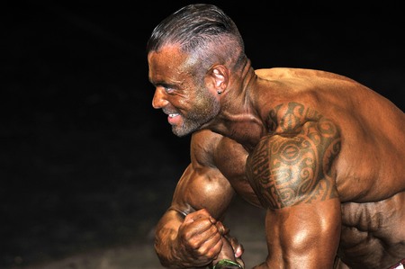 ROOSENDAAL, THE NETHERLANDS - OCTOBER 19, 2014. Walters Open Dutch Championship 2014 - category bodybuilding and fitness men. Male bodybuilders showing their best at the bodybuilding and fitness contest at the Walter's Open Dutch Championship Bodybuildingのeditorial素材