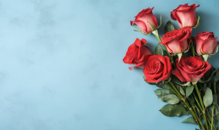 A red rose bouquet on a blue background. Empty copyspace. mother's day concept. flat lay. Created with generative AI toolsの素材
