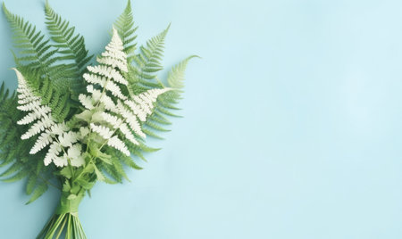A green fern bouquet on a pastel blue background with empty copyspace. botanical concept. flat lay. Created with generative AI toolsの素材