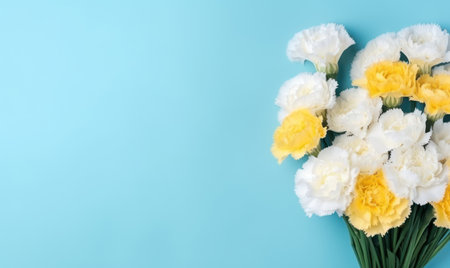 Close-up of yellow and white carnations, representing love and fascination, beautifully juxtaposed with a serene blue background. AI Generativeの素材