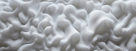 Macro shot of white foam texture, resembling a soft cloud landscape.の素材