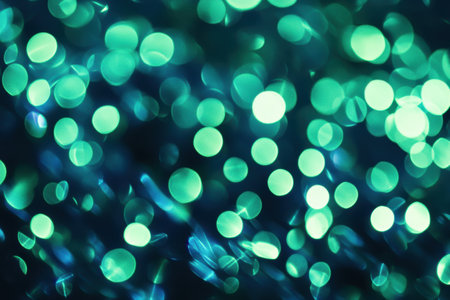 Abstract green bokeh with soft light effects creating a dreamy and elegant background.の素材