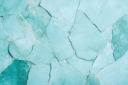 Abstract turquoise cracked wall with intricate patterns and textures creating a unique artistic background.の素材
