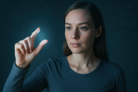 Confident woman interacting with futuristic touch interface on dark background, demonstrating modern technology and digital innovation.の素材