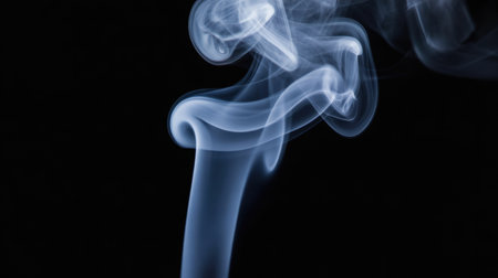 Blue swirling smoke rising gracefully against a dark background with smooth, flowing abstract shapes and delicate wispy patterns.の素材