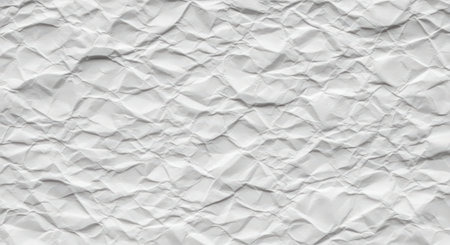 Crumpled white paper surface with detailed creases and textured folds creating an abstract pattern in a neutral background.の素材