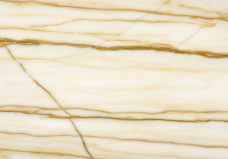 Elegant cream marble surface with gold veining pattern and natural polished texture for luxury interior design and modern architecture.の素材