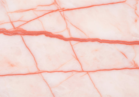 Light pink marble surface with natural orange veins and subtle texture, elegant minimal background for interiors and design projects.の素材