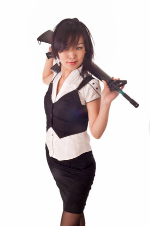 Beautiful asian girl with rifle on her shoulders isolated on whiteの写真素材