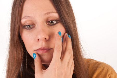 a pretty girl with blue nails isolated on whiteの写真素材