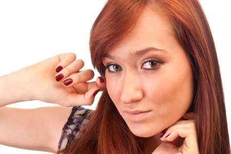 beautiful red-haired girl with red nails isolated on whiteの写真素材