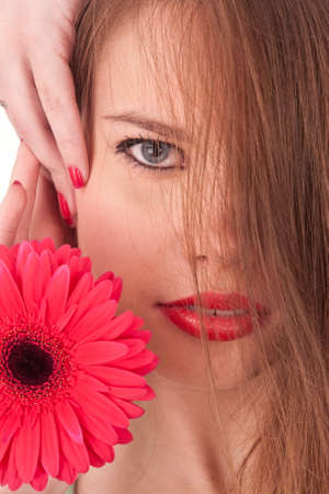 the beautiful girl with red flower, red lips and red nailsの写真素材