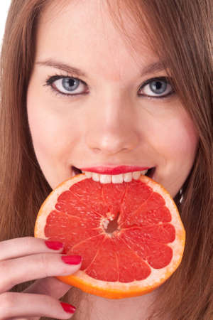 the beautiful girl  with red lips and grapefruit isolated on whiteの写真素材