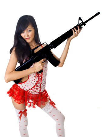 sexy asian female with rifle isolated on whiteの写真素材