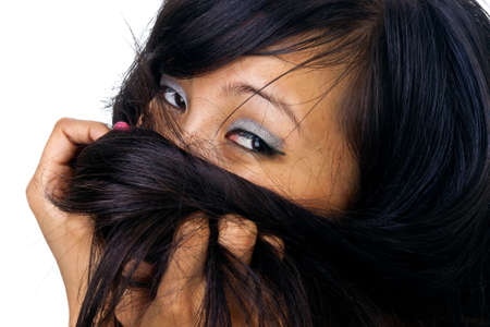 asian female eyes and hair closeup portrait isolated on whiteの写真素材