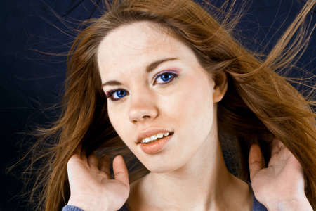 blue eyes girl and hair streaming with the windの写真素材