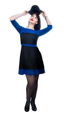 female stand holding a black hat isolated on whiteの写真素材