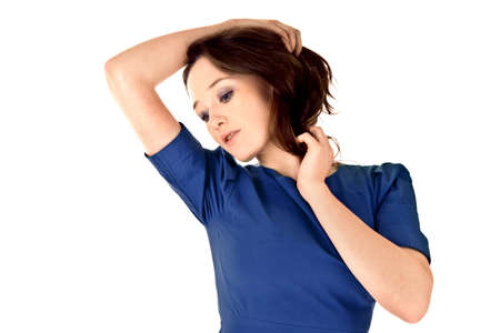 modest girl in blue dress isolated on the whiteの写真素材