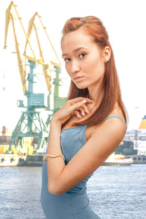 a beautiful girl on the background of cranes commercial portの写真素材