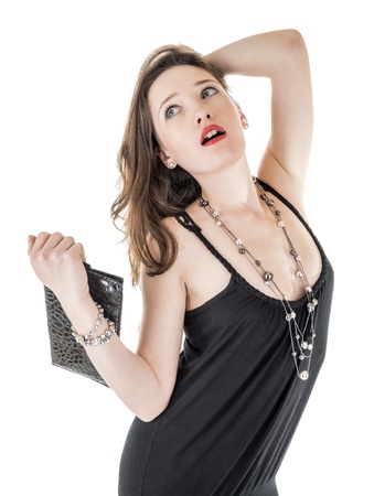 a pretty female  dressed in a black dress with her purse and necklace isolated on whiteの写真素材