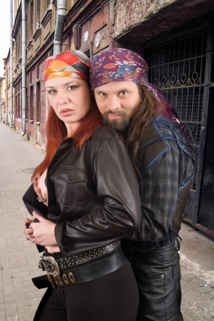 two of hipsters hug on a city streetの写真素材