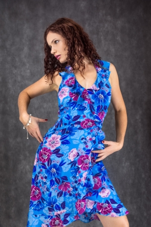 pretty woman dressed in a blue dress with red flowersの写真素材