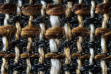 Texture of cloth material for design. Abstract background with white, black, gray and brown threads...
