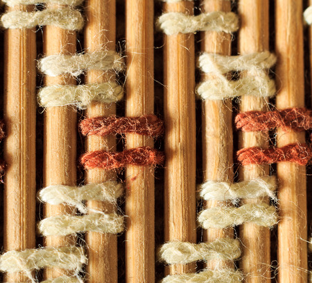 Texture of old bamboo branches with threads. Abstract background for design.
