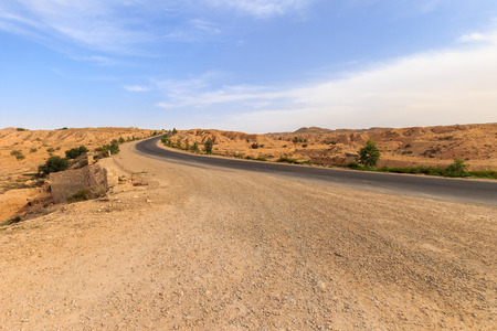 Road at Sahara desert in the afternoon. Montain landscape.の写真素材