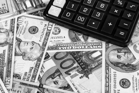 Background with money american dollar and euro bills and black calculator. Cash money. Black and white image.の写真素材