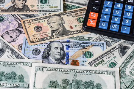 Background with money american dollar bills and black calculator. Cash money.の写真素材