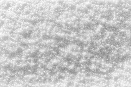 Snow texture at sunny winter day. Abstract background with shadows and highlights.の写真素材