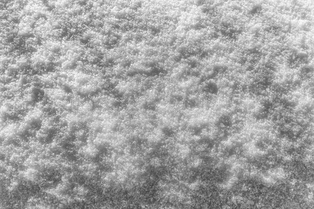 Snow texture at sunny winter day. Abstract background with shadows and highlights.の写真素材