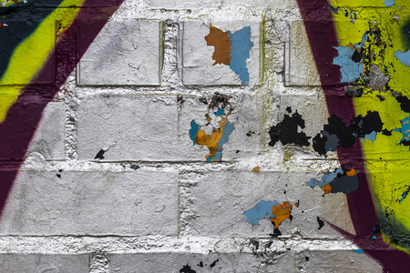 Fragment of colored graffiti painted on a brick wall. Texture. Abstract background for design.の写真素材