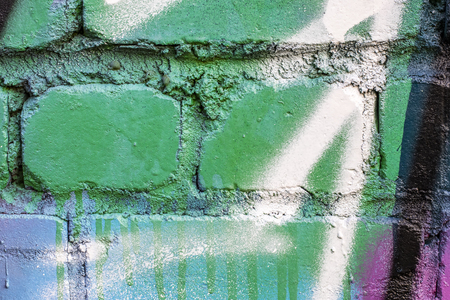 Fragment of colored graffiti painted on a brick wall. Texture. Abstract background for design.の写真素材