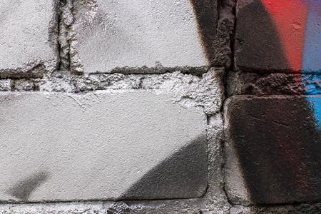Fragment of colored graffiti painted on a brick wall. Texture. Abstract background for design.の写真素材